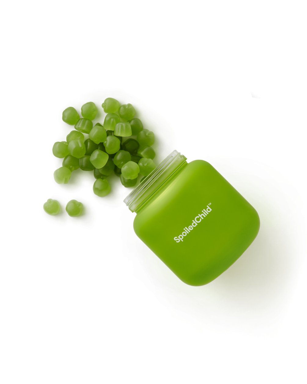 A green, square SpoiledChild J29 jar tilted on its side with small, round green gummy supplements spilling out onto a white surface.